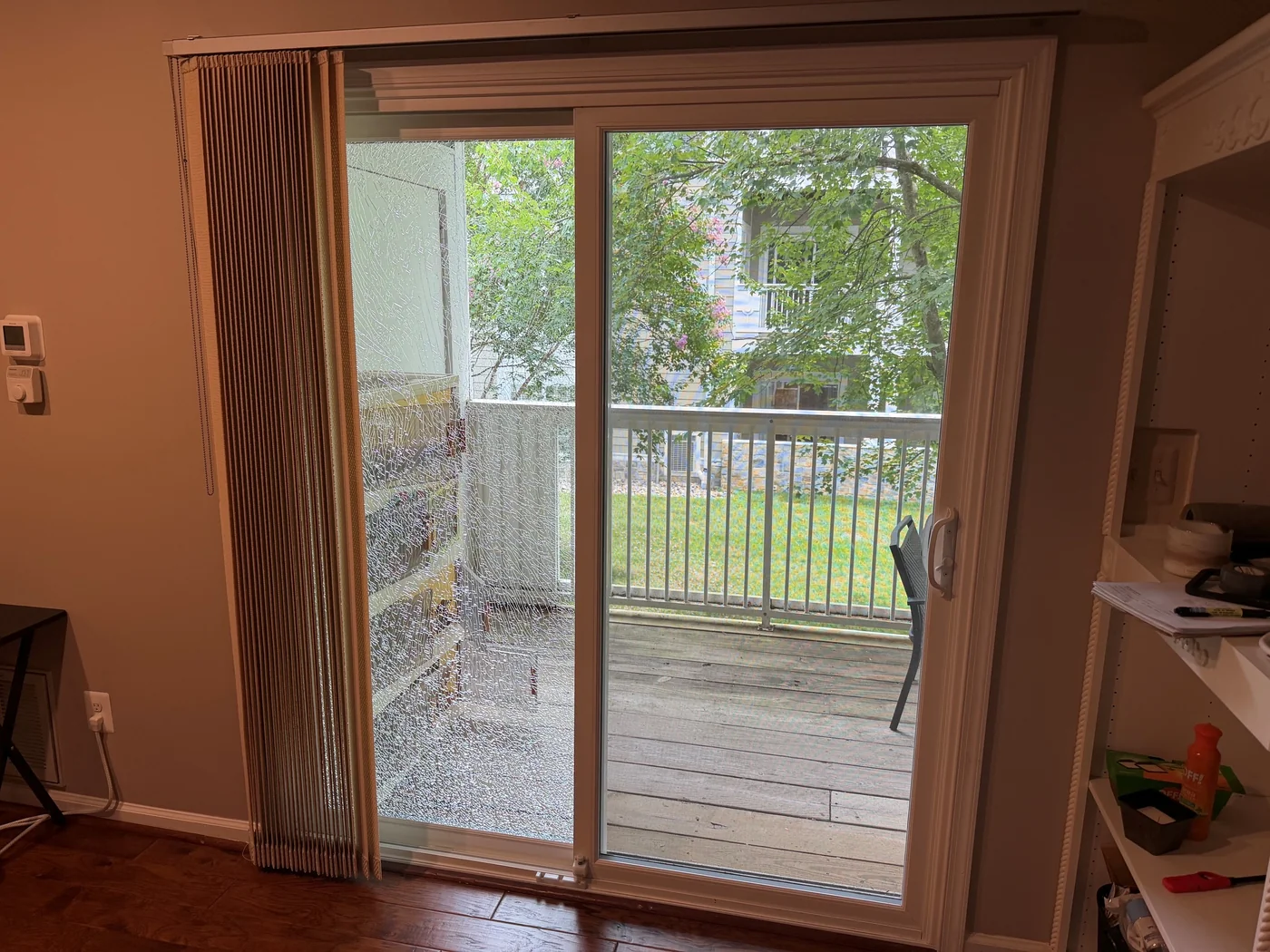 Sliding patio glass door with a white frame.
