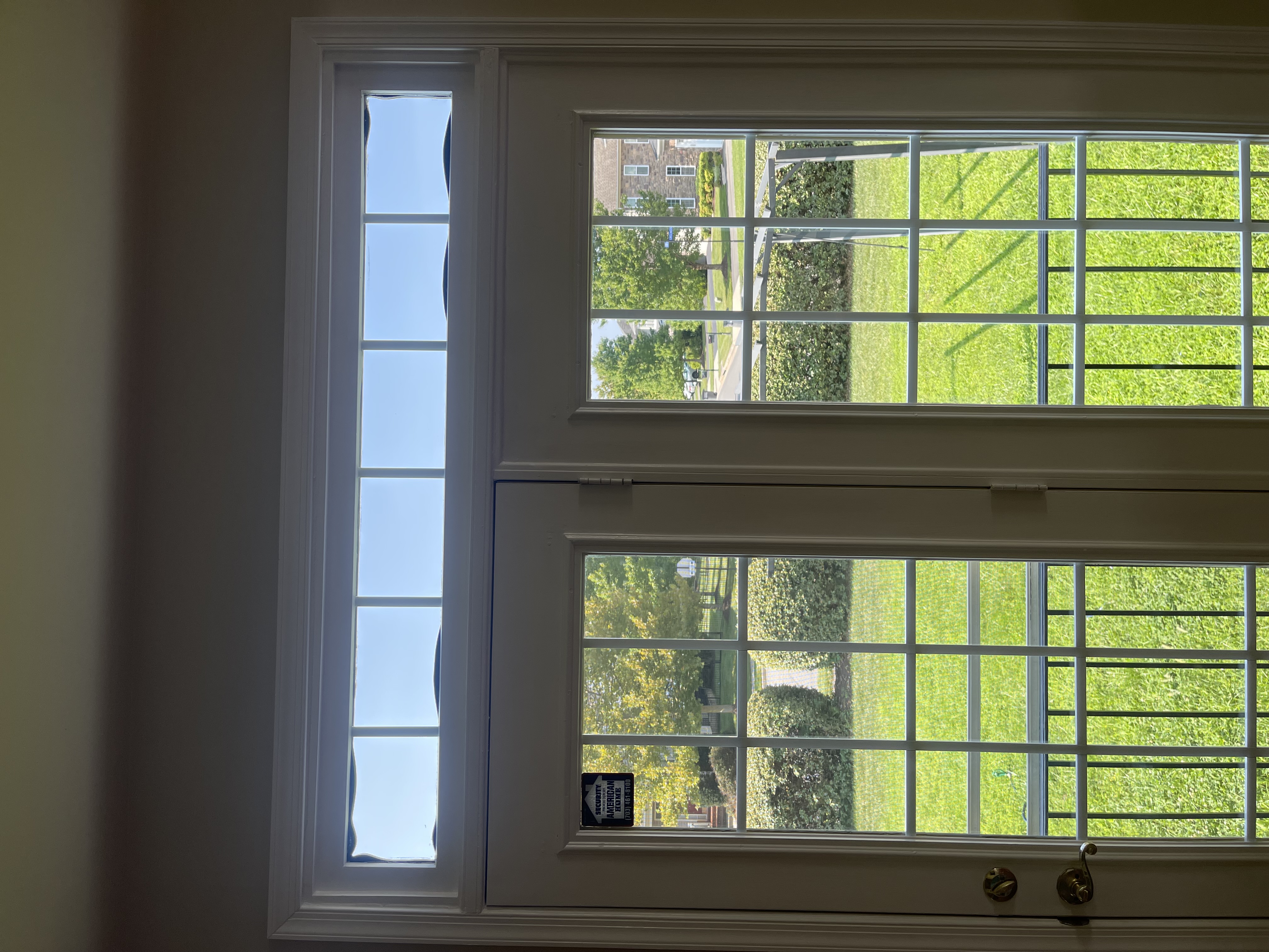 Black seal material bulging into the glass around a narrow transom window