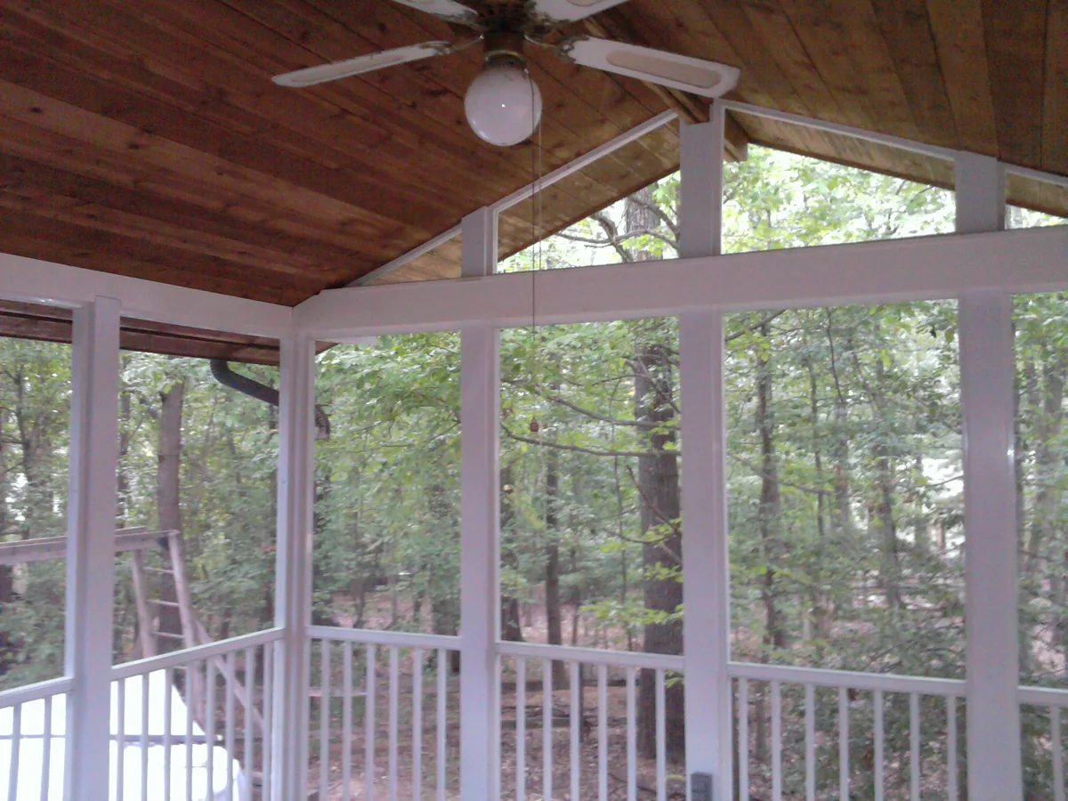 Tall porch screen panels beneath a wood cathedral ceiling