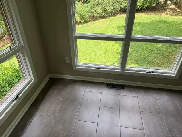 Corner windows overlooking a landscaped yard