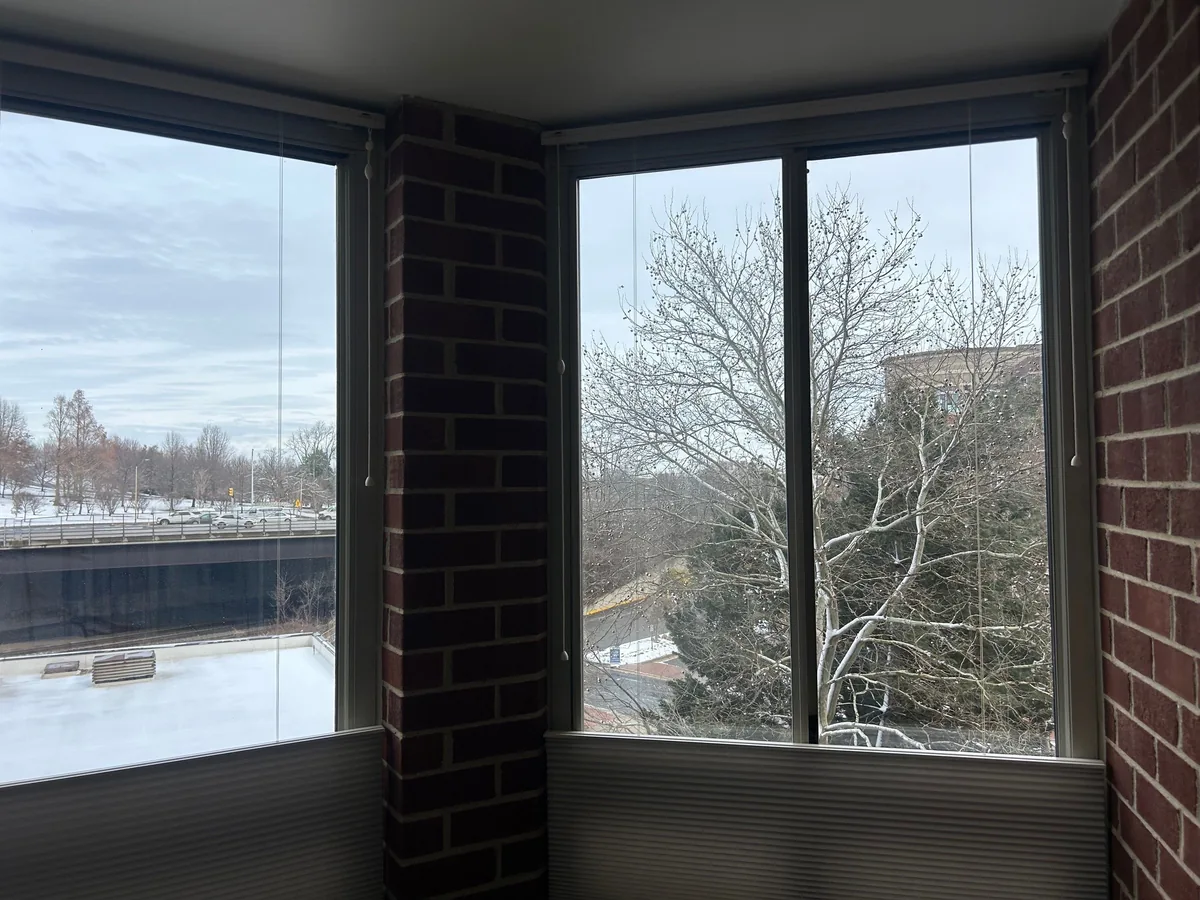 Corner windows set between exposed brick walls