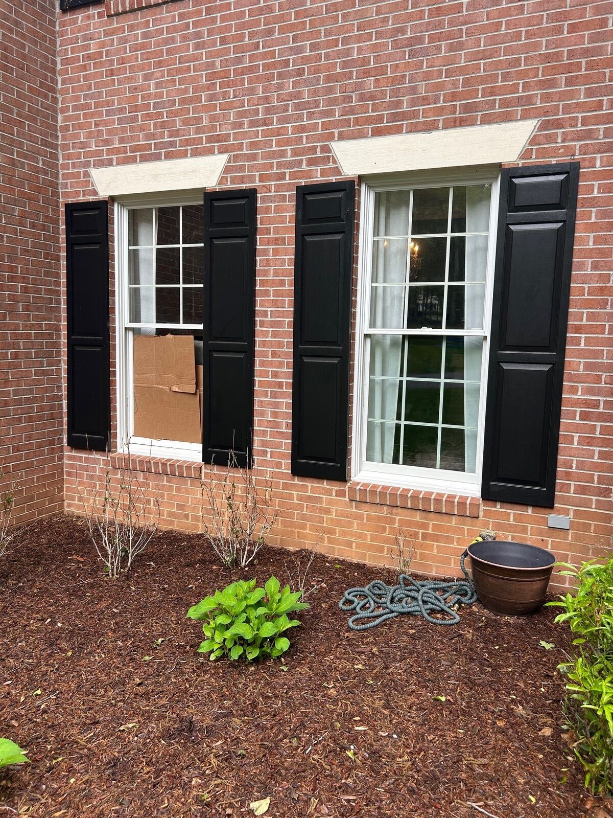 Two grid windows with one lower pane covered by a board