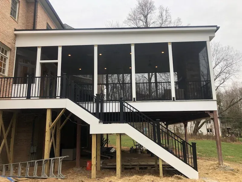 Raised screened porch with long exterior stairs.