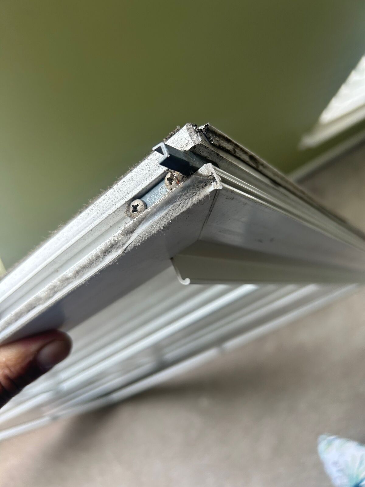 Close-up of the corner profile of a window sash removed from its frame