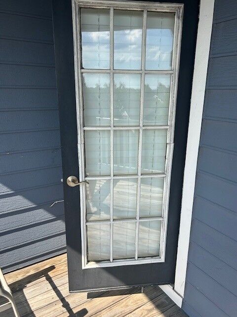 A patio door with grids in the glass, seen from outside