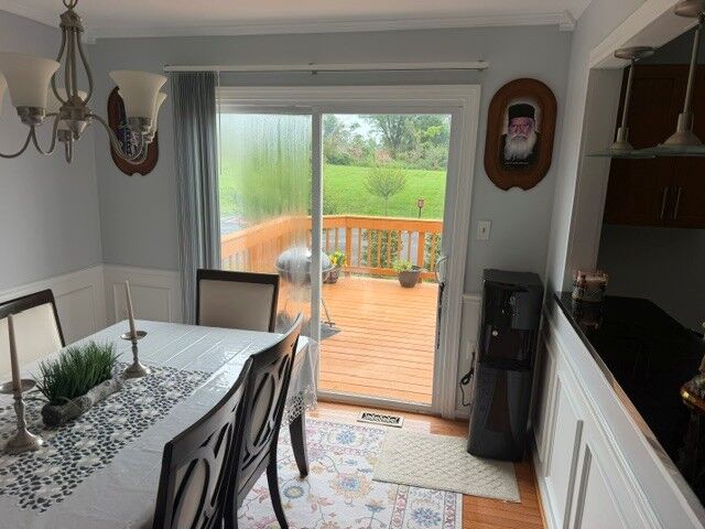 Condensation in the left glass panel of a patio door beside a dining room