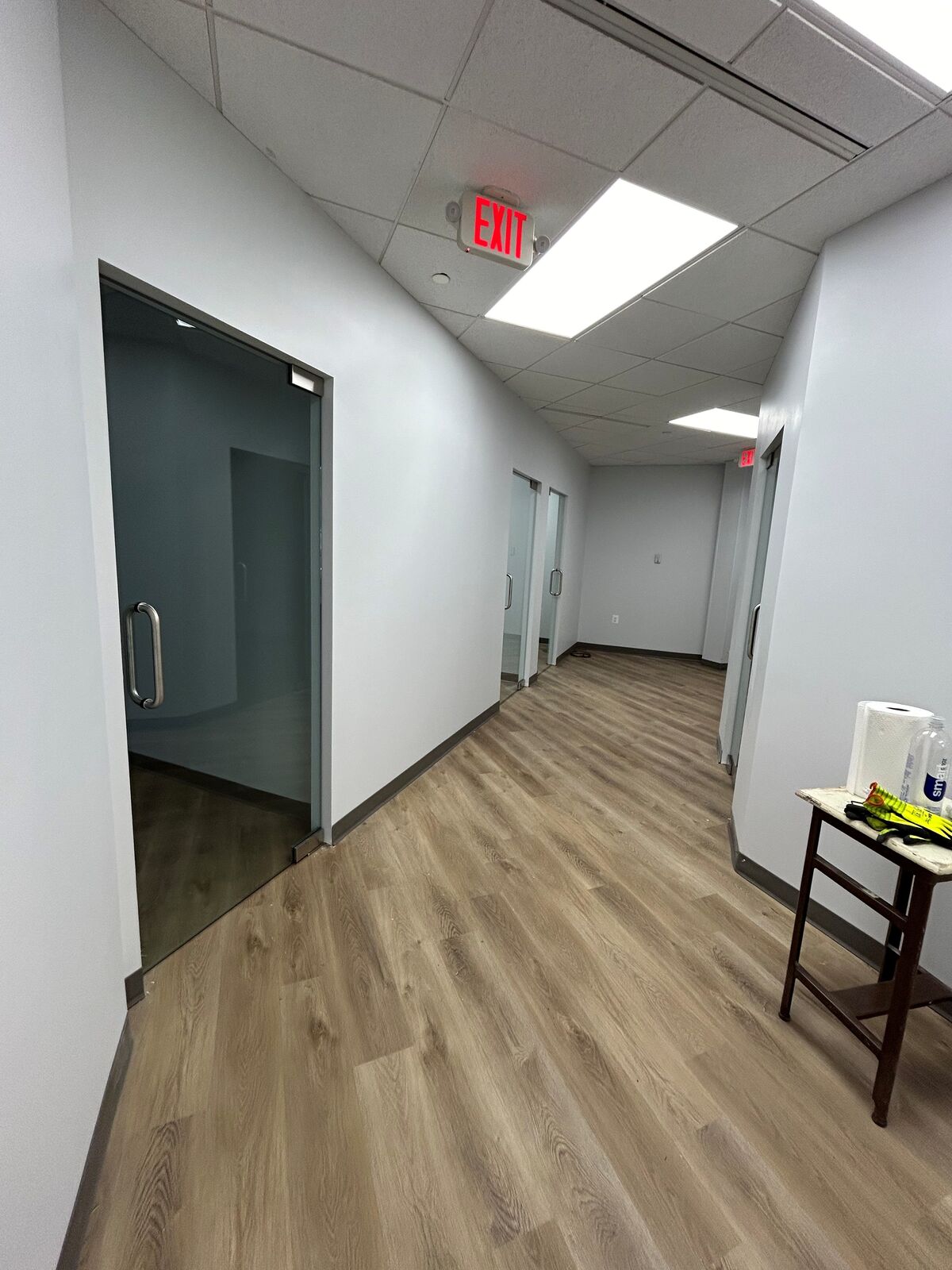 An office corridor lined with frosted glass doors