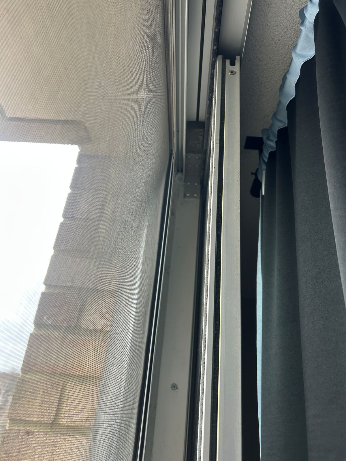 Close-up of the side track of a balcony sliding door