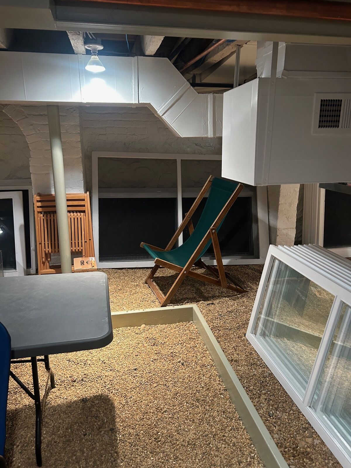 Windows and screens laid out in a basement work area
